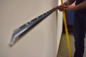 Man installing a markerboard