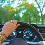 A women's hand on a steering wheel