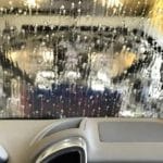 Inside view of a car windshield covered in soapy water.