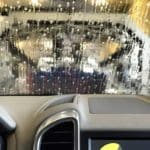 A front view from inside the vehicle with a soapy water covered windshield.