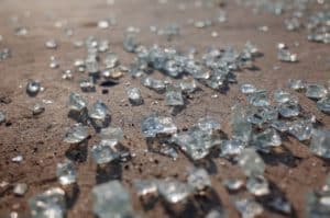 Shattered glass pieces on a concert floor.