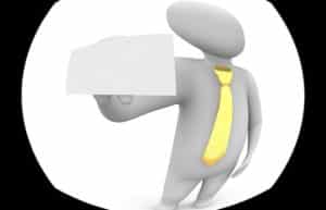 A clipart figure with a long, yellow tie holding up a horizontal piece of blank paper.
