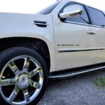 A side view of a beige Escalade.