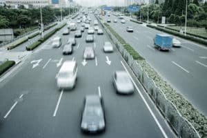A view of cars driving on a 4 lined highway.
