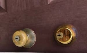 Old, wore golden handle and door lock