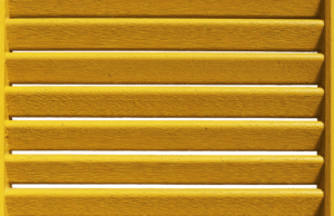 A close up of a light brown window shutter.