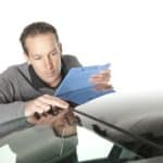 Man inspecting a windshield