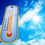Temperature gauge in a blue sky.