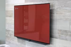 A flat screened tv hanging on a wall.