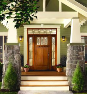 A wooden front door with transom windows.