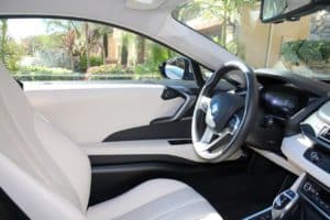 Inside of a white leather seat car.