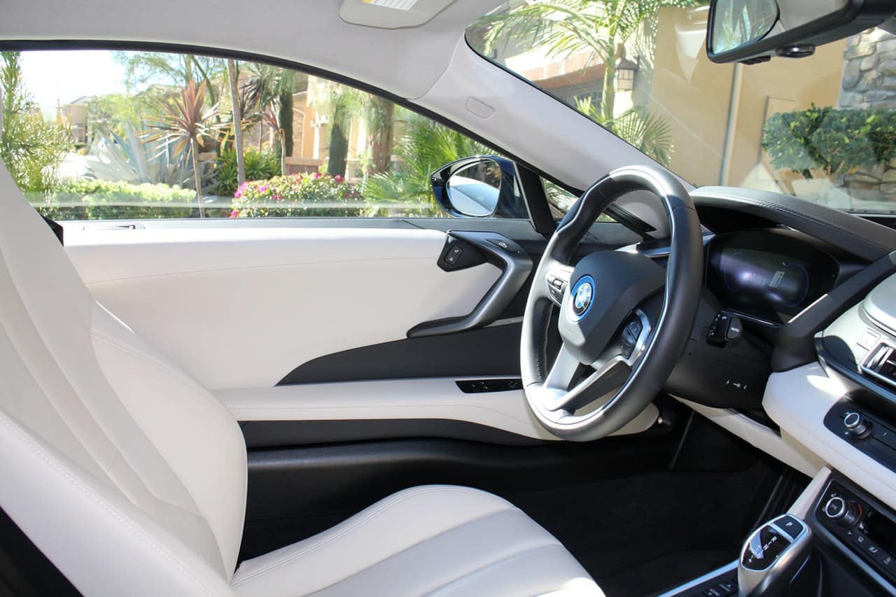 Inside of a white leather seat car.