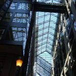 A look up view of a ceiling of glass canopies.