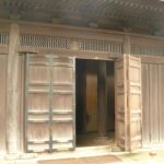 An open, wooden bi-fold leading into a shop.