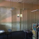 A white multi-fold door in an office area.