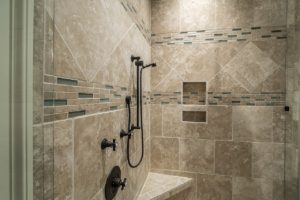Looking into a tan tiled shower.