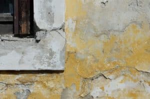 A close up have a concrete wall that is orange and gray.