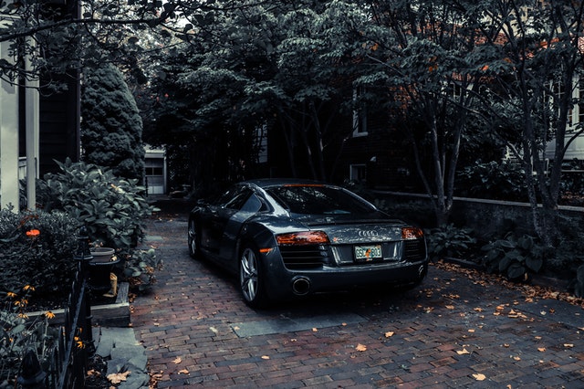 a black car-parked-under-trees