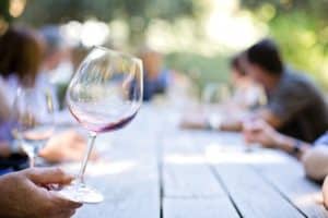 red wine glass being held by the bottom