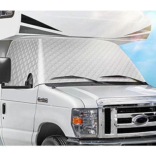 White RV windshield cover sits on a white RV windshield being held down with wiper blades