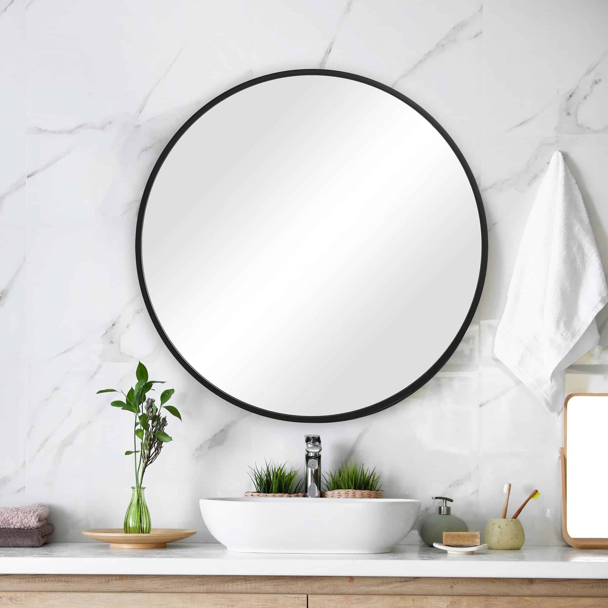 Sag Harbor Medium Black Round Mirror hanging above a bathroom sink
