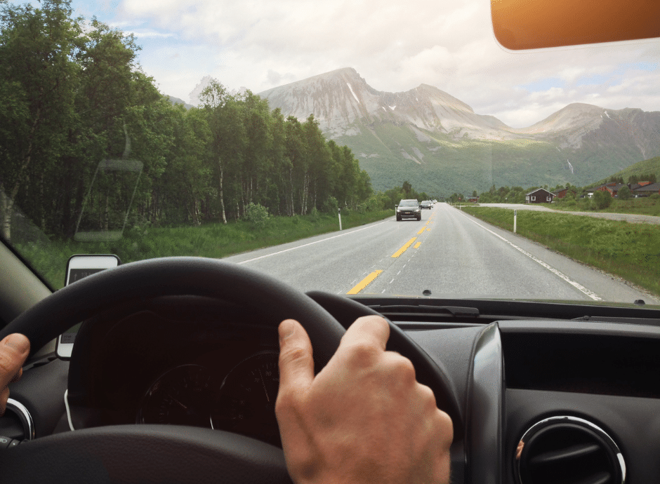 Driving in the mountains with a clear windshield without damage to be able to see.